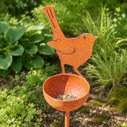 Detalle del pájaro decorativo y de la pequeña bandeja para semillas
