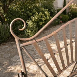Detalle de arabescos y respaldo del banco de jardín de hierro forjado